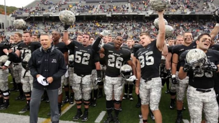 Oct 11, 2014; West Point, NY, USA; Army Black Knights head coach Jeff Monken stand with offensive lineman Corey Hobbs (52) and running back Kahill Harper (26) and kicker Daniel Grochowski (95) during the West Point alma mater after losing to the Rice Owls 41-21 at Michie Stadium. Mandatory Credit: Danny Wild-USA TODAY Sports
