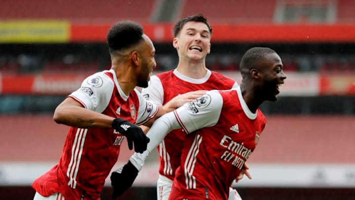 Arsenal's French-born Ivorian midfielder Nicolas Pepe (R) celebrates scoring his team's second goal during the English Premier League football match between Arsenal and Sheffield United at the Emirates Stadium in London on October 4, 2020. (Photo by Kirsty Wigglesworth / POOL / AFP) / RESTRICTED TO EDITORIAL USE. No use with unauthorized audio, video, data, fixture lists, club/league logos or 'live' services. Online in-match use limited to 120 images. An additional 40 images may be used in extra time. No video emulation. Social media in-match use limited to 120 images. An additional 40 images may be used in extra time. No use in betting publications, games or single club/league/player publications. / (Photo by KIRSTY WIGGLESWORTH/POOL/AFP via Getty Images)