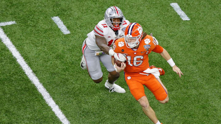 Jan 1, 2021; New Orleans, LA, USA; Clemson Tigers quarterback Trevor Lawrence (16) runs with the ball as Ohio State Buckeyes defensive end Tyreke Smith (11) chases during the third quarter at Mercedes-Benz Superdome. Mandatory Credit: Russell Costanza-USA TODAY Sports