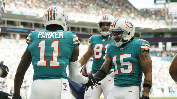 MIAMI, FLORIDA – DECEMBER 01: DeVante Parker #11 of the Miami Dolphins celebrates with teammates after a touchdown against the Philadelphia Eagles during the first quarter at Hard Rock Stadium on December 01, 2019 in Miami, Florida. (Photo by Michael Reaves/Getty Images)