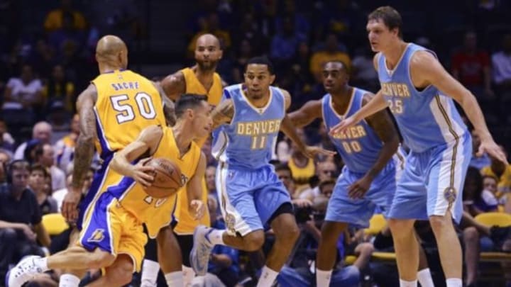 Oct 6, 2014; San Diego, CA, USA; Los Angeles Lakers guard Steve Nash (10) is defended by Denver Nuggets center Timofey Mozgov (25) during the first half at Valley View Casino Center. Mandatory Credit: Jake Roth-USA TODAY Sports