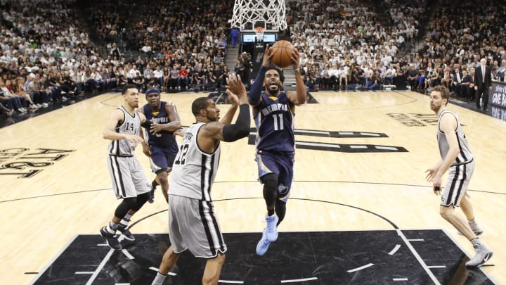 Apr 15, 2017; San Antonio, TX, USA; Memphis Grizzlies point guard Mike Conley (11) shoots the ball as San Antonio Spurs power forward LaMarcus Aldridge (12) defends during the first half in game one of the first round of the 2017 NBA Playoffs at AT&T Center. Mandatory Credit: Soobum Im-USA TODAY Sports