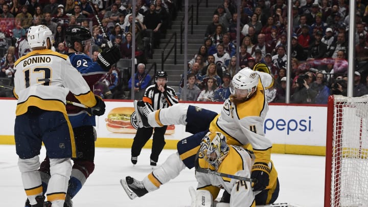 DENVER, CO – APRIL 16: Colorado Avalanche left wing Gabriel Landeskog #92 pushes Nashville Predators defenseman Ryan Ellis #4 over his goalie Nashville Predators goaltender Juuse Saros #74 in the third period during the third game of round one of the Stanley Cup Playoffs at Pepsi Center April 16, 2018. Avalanche won 5-3. (Photo by Andy Cross/The Denver Post via Getty Images)