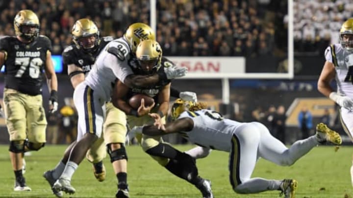 Nov 3, 2016; Boulder, CO, USA; UCLA Bruins defensive lineman Takkarist McKinley (98) and linebacker Jayon Brown (12) tackle the scramble of Colorado Buffaloes quarterback Sefo Liufau (13) in the first half at Folsom Field. Mandatory Credit: Ron Chenoy-USA TODAY Sports