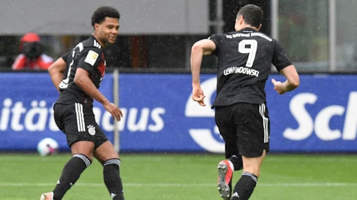 Bayern Munich striker Robert Lewandowski celebrating with Serge Gnabry against Freiburg.(Photo by THOMAS KIENZLE/POOL/AFP via Getty Images)