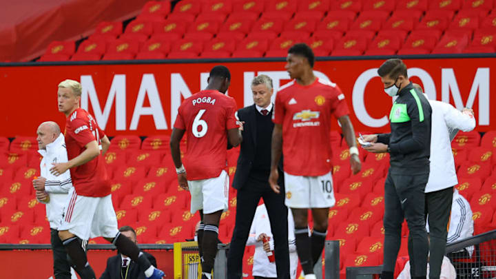 MANCHESTER, ENGLAND - SEPTEMBER 19: Ole Gunnar Solskjaer, Manager of Manchester United greets Paul Pogba of Manchester United as he is substituted off during the Premier League match between Manchester United and Crystal Palace at Old Trafford on September 19, 2020 in Manchester, England. (Photo by Richard Heathcote/Getty Images )