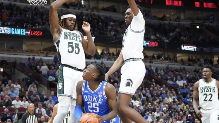 Nov 14, 2023; Chicago, Illinois, USA; Michigan State Spartans guard Tre Holloman (5) defends Duke Blue Devils forward Mark Mitchell (25) during the first half at United Center. Mandatory Credit: David Banks-USA TODAY Sports