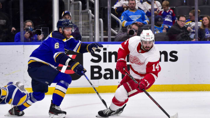 Dec 9, 2021; St. Louis, Missouri, USA; Detroit Red Wings center Robby Fabbri (14) controls the puck as St. Louis Blues defenseman Marco Scandella (6) defends during the third period at Enterprise Center. Mandatory Credit: Jeff Curry-USA TODAY Sports