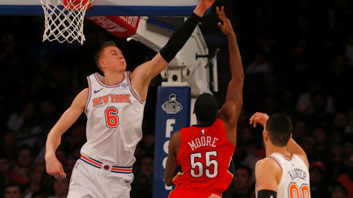 NEW YORK, NY - JANUARY 14: (NEW YORK DAILIES OUT) Kristaps Porzingis #6 of the New York Knicks in action against E'Twaun Moore #55 of the New Orleans Pelicans at Madison Square Garden on January 14, 2018 in New York City. The Pelicans defeated the Knicks 123-118 in overtime. NOTE TO USER: User expressly acknowledges and agrees that, by downloading and/or using this Photograph, user is consenting to the terms and conditions of the Getty Images License Agreement. (Photo by Jim McIsaac/Getty Images)