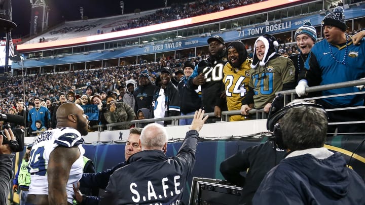 JACKSONVILLE, FL – DECEMBER 10: Defensive End Quinton Jefferson No. 99 of the Seattle Seahawks confronted a group of Jaguars fans after he was nearly hit by flying objects thrown from the stands. Jefferson had to be restrained by Seahawks staff and ushered into the locker room in the last few seconds of the game against the Jacksonville Jaguars at EverBank Field on December 10, 2017 in Jacksonville, Florida. The Jaguars defeated the Seahawks 30 to 24. (Photo by Don Juan Moore/Getty Images)