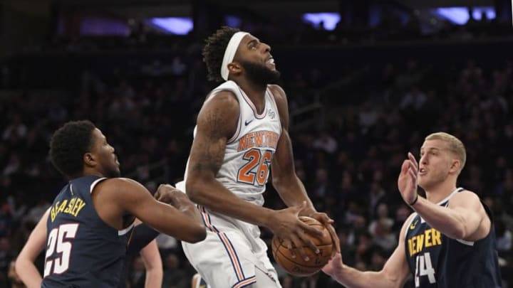 NEW YORK, NEW YORK - MARCH 22: Mitchell Robinson #26 of the New York Knicks attempts a basket against Malik Beasley #25 and Mason Plumlee #24 of the Denver Nuggets during the second half of the game at Madison Square Garden on March 22, 2019 in New York City. NOTE TO USER: User expressly acknowledges and agrees that, by downloading and or using this photograph, User is consenting to the terms and conditions of the Getty Images License Agreement. (Photo by Sarah Stier/Getty Images)