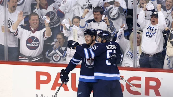 NHL DFS: WINNIPEG, MANITOBA - APRIL 20: Jacob Trouba #8 and Mark Scheifele #55 of the Winnipeg Jets celebrate Trouba's goal in Game Five of the Western Conference First Round during the 2018 NHL Stanley Cup Playoffs against the Minnesota Wild on April 20, 2018 at Bell MTS Place in Winnipeg, Manitoba, Canada. (Photo by Jason Halstead /Getty Images) *** Local Caption *** Jacob Trouba; Mark Scheifele