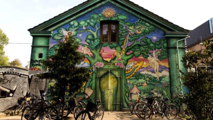 COPENHAGEN, DENMARK AUGUST 31: A building façade with street art seen at the freetown Christiania on August 31, 2019 in Copenhagen, Denmark. Christiania is a special quarter of Copenhagen based on alternative living and consensus democracy, established by squatters at a 34 hectare military area and barracks in 1971, today characterized by a more complex social structure from organized crime based on hash pushers to many small and lawful business. Christiania is one of the most important tourist attractions in Copenhagen. (Photo by Ole Jensen/Getty Images)
