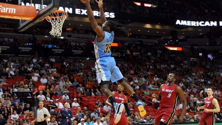 Mar 14, 2016; Miami, FL, USA; Denver Nuggets forward Kenneth Faried (35) dunks the ball past Miami Heat forward Luol Deng (9) during the first half at American Airlines Arena. Mandatory Credit: Steve Mitchell-USA TODAY Sports
