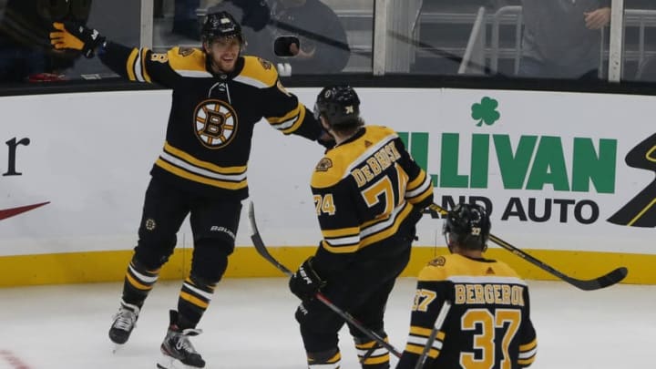 BOSTON - OCTOBER 14: Boston Bruins' David Pastrnak, (88, far left) celebrates his goal against the Anaheim Ducks with Bruins teammates Jake DeBrusk (74) and Patrice Bergeron (37) during the first period. The Boston Bruins host the Anaheim Ducks in a regular season NHL hockey game at TD Garden on Oct. 14, 2019. (Photo by Jessica Rinaldi/The Boston Globe via Getty Images)