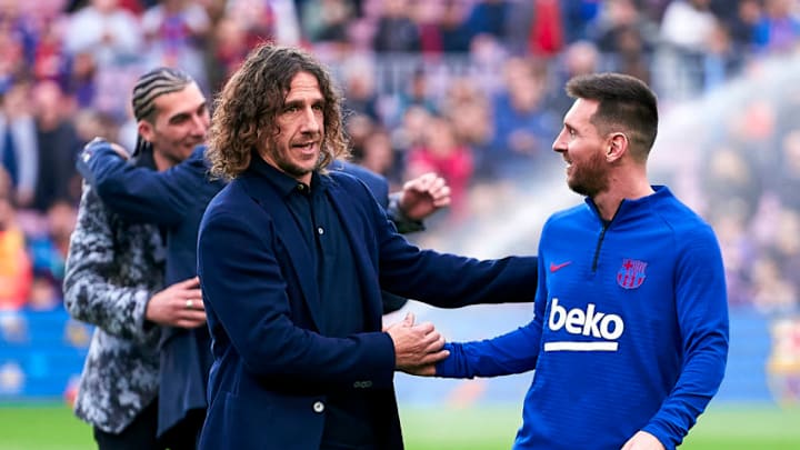 Carles Puyol and Lionel Messi of Barcelona