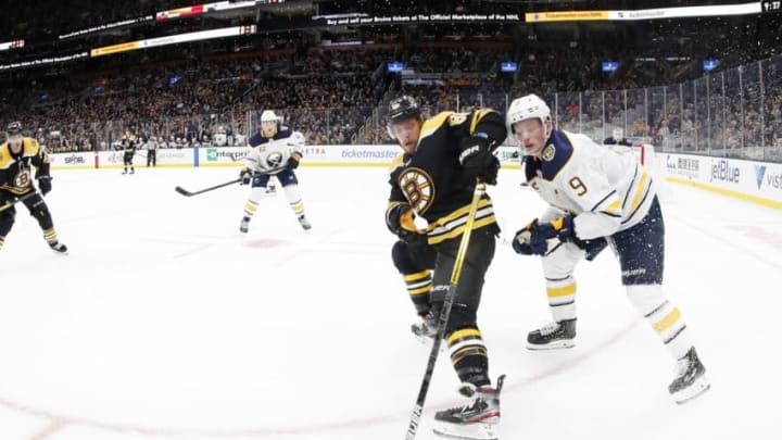 BOSTON, MA - NOVEMBER 21: Boston Bruins right wing David Pastrnak (88) plays the puck with Buffalo Sabres center Jack Eichel (9) on his back during a game between the Boston Bruins and the Buffalo Sabres on November 21, 2019, at TD Garden in Boston, Massachusetts. (Photo by Fred Kfoury III/Icon Sportswire via Getty Images)