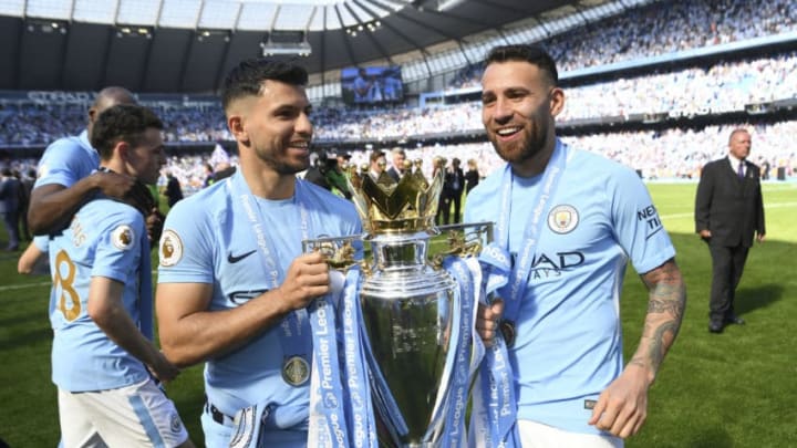MANCHESTER, ENGLAND - MAY 06: Sergio Aguero and Nicolas Otamendi with the Premier league trophy after the Premier League match between Manchester City and Huddersfield Town at Etihad Stadium on May 6, 2018 in Manchester, England. (Photo by Michael Regan/Getty Images)