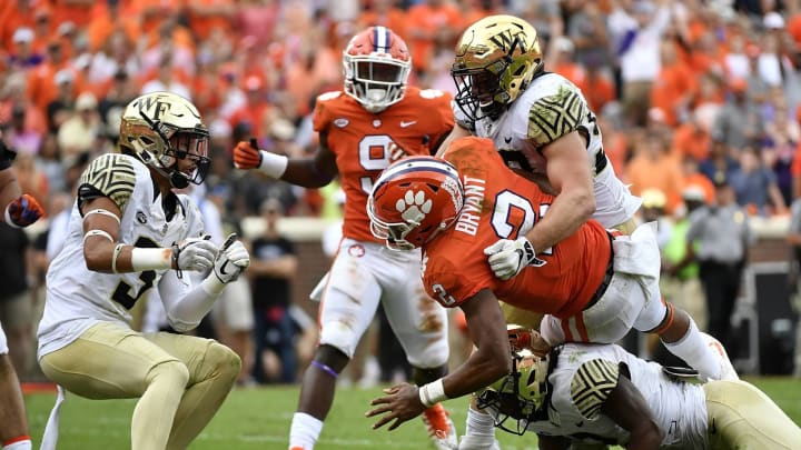 CLEMSON, SC – OCTOBER 07: Linebacker Grant Dawson #50 and defensive back Cameron Glenn #2 of the Wake Forest Demon Deacons tackle quarterback Kelly Bryant #2 of the Clemson Tigers causing an ankle injury that would force Bryant to leave the game at Memorial Stadium on October 7, 2017 in Clemson, South Carolina. (Photo by Mike Comer/Getty Images)