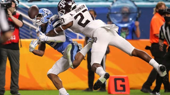 Jan 2, 2021; Miami Gardens, FL, USA; North Carolina Tar Heels wide receiver Dazz Newsome (5) catches football for a touchdown as Texas A&M Aggies defensive back Antonio Johnson (27) defends during the second quarter of the game at Hard Rock Stadium. Mandatory Credit: Sam Navarro-USA TODAY Sports