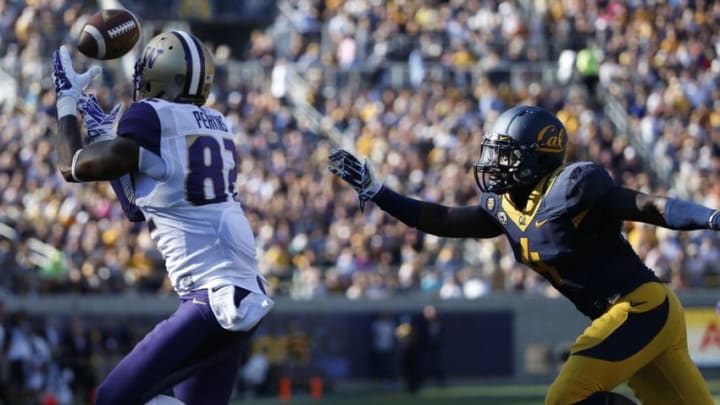BERKELEY, CA - OCTOBER 11: Tightend Joshua Perkins #82 of the Washington Huskies catches a 25-yard touchdown pass as safety Avery Sebastian #4 of the California Golden Bears defends during the first quarter of their game on October 11, 2014 at California Memorial Stadium in Berkeley, California. (Photo by Stephen Lam/Getty Images)