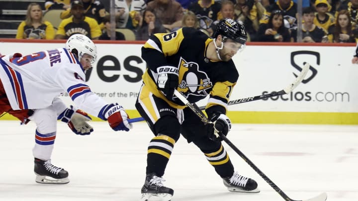 May 9, 2022; Pittsburgh, Pennsylvania, USA; Pittsburgh Penguins left wing Jason Zucker (16) carries the puck against New York Rangers left wing Alexis Lafrenière (13) during the second period in game four of the first round of the 2022 Stanley Cup Playoffs at PPG Paints Arena. Mandatory Credit: Charles LeClaire-USA TODAY Sports
