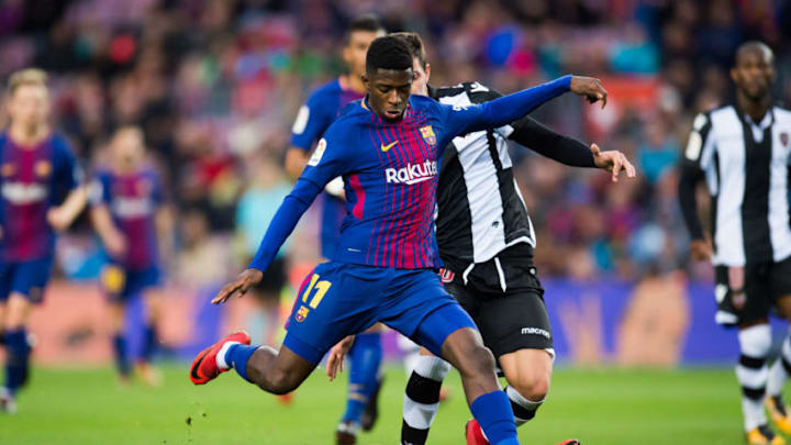 BARCELONA, SPAIN - JANUARY 07: Ousmane Dembele of FC Barcelona kicks the ball under pressure from Sasa Lukic of Levante UD during the La Liga match between Barcelona and Levante at Camp Nou on January 7, 2018 in Barcelona, Spain. (Photo by Alex Caparros/Getty Images)