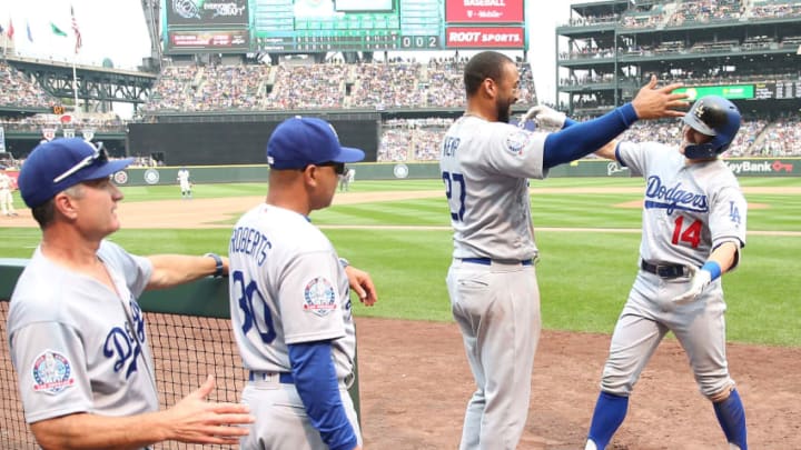SEATTLE, WA - AUGUST 19: Enrique Hernandez #14 (R) hugs teammate Matt Kemp #27 of the Los Angeles Dodgers after hitting a solo home run against the in the sixth inning during their game at Safeco Field on August 19, 2018 in Seattle, Washington. (Photo by Abbie Parr/Getty Images)