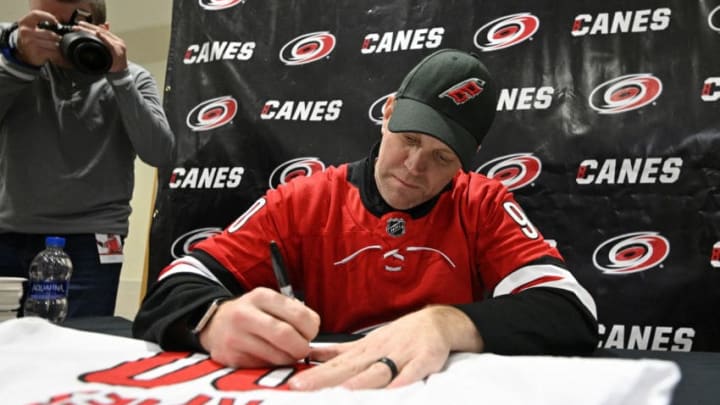 RALEIGH, NORTH CAROLINA - FEBRUARY 25: Dave Ayres signs autographs for fans during the game between the Dallas Stars and Carolina Hurricanes at at PNC Arena on February 25, 2020 in Raleigh, North Carolina. Ayres, in emergency relief, recorded eight saves, the win and first-star honors in his National Hockey League debut with the Carolina Hurricanes in their game against the Toronto Maple Leafs on February 22. (Photo by Grant Halverson/Getty Images)