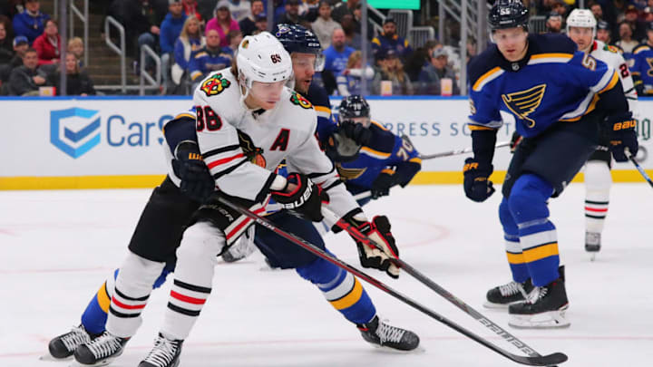 ST. LOUIS, MO - FEBRUARY 25: Patrick Kane #88 of the Chicago Blackhawks fights Marco Scandella #6 of the St. Louis Blues for control of the puck during the third period at the Enterprise Center on February 25, 2020 in St. Louis, Missouri. (Photo by Dilip Vishwanat/Getty Images)