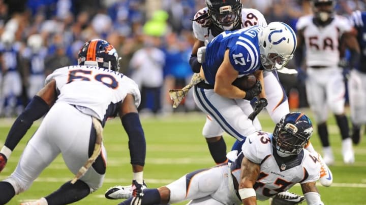 Nov 8, 2015; Indianapolis, IN, USA; Indianapolis Colts receiver Griff Whalen (17) is tackled by a group of Denver Bronco defenders in the first half at Lucas Oil Stadium. Mandatory Credit: Thomas J. Russo-USA TODAY Sports