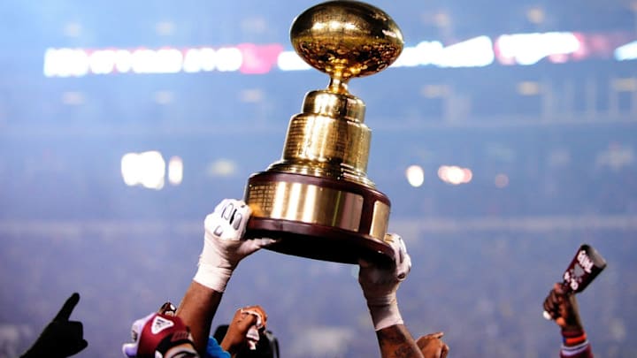 STARKVILLE, MS - NOVEMBER 28: Members of the Mississippi State Bulldogs hold the "Golden Egg" trophy following a victory over the Ole Miss Rebels at Davis Wade Stadium on November 28, 2013 in Starkville, Mississippi. Mississippi State won the game 17-10. (Photo by Stacy Revere/Getty Images)