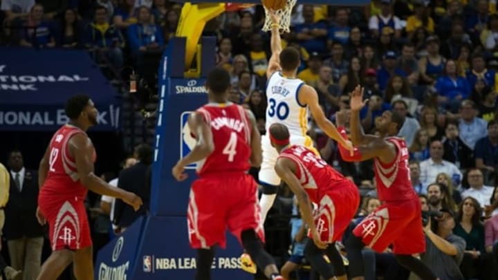 Oct 15, 2015; Oakland, CA, USA; Golden State Warriors guard Stephen Curry (30) goes up for a layup above Houston Rockets players during the second quarter at Oracle Arena. Mandatory Credit: Kelley L Cox-USA TODAY Sports