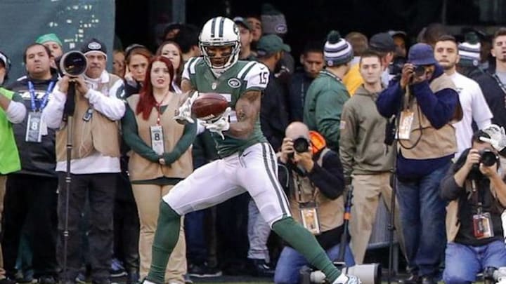 Dec 27, 2015; East Rutherford, NJ, USA; New York Jets wide receiver Brandon Marshall (15) makes reception and carries the ball in for touchdown during the second quarter against the New England Patriots at MetLife Stadium. Mandatory Credit: Jim O