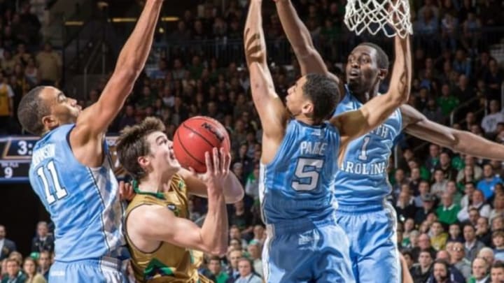 Feb 6, 2016; South Bend, IN, USA; Notre Dame Fighting Irish guard Steve Vasturia (32) goes up for a shot as North Carolina Tar Heels forward Brice Johnson (11) guard Marcus Paige (5) and forward Theo Pinson (1) defends in the second half at the Purcell Pavilion. Notre Dame won 80-76. Mandatory Credit: Matt Cashore-USA TODAY Sports