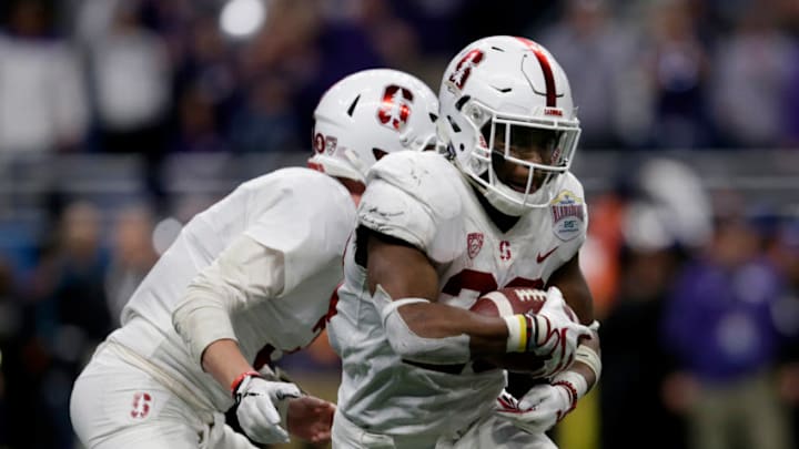 K.J. Costello #3 of the Stanford Cardinal hands off to Bryce Love #20 (Photo by Tim Warner/Getty Images)