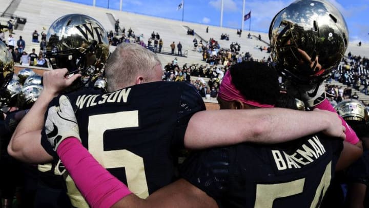 WINSTON SALEM, NC - OCTOBER 28: Long snapper Garrett Wilson #15 and defensive lineman Elontae Bateman #54 of the Wake Forest Demon Deacons celebrate their win over the Louisville Cardinals in the football game at BB&T Field on October 28, 2017 in Winston Salem, North Carolina. (Photo by Mike Comer/Getty Images)