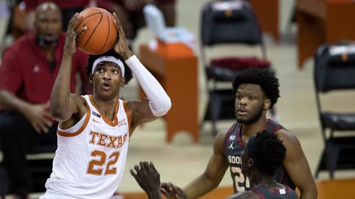 Apr 4, 2020; Austin, TX, USA; Texas Longhorns forward Kai Jones (22) drives and scores against Oklahoma Sooners guard Elijah Harkless (24) and forward Kur Kuath (52) in the first half at the Frank Erwin Center. Mandatory Credit: Ricardo B. Brazziell/American-Statesman via USA TODAY NETWORK