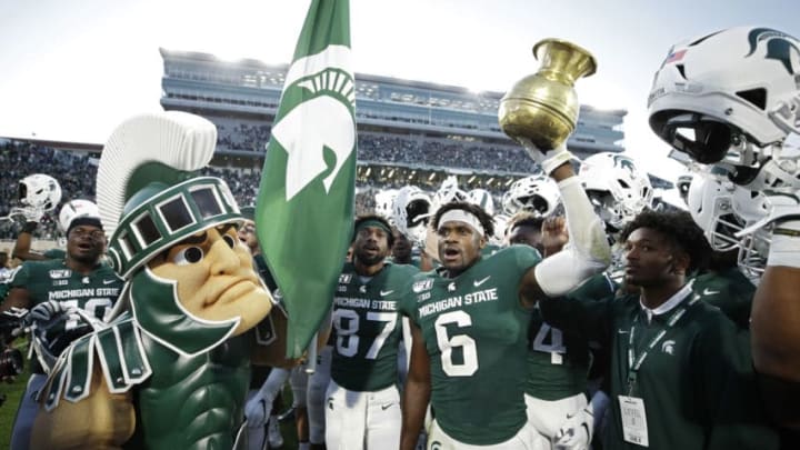 EAST LANSING, MI - SEPTEMBER 28: Michigan State Spartans players celebrate with the Old Brass Spittoon after the game against the Indiana Hoosiers at Spartan Stadium on September 28, 2019 in East Lansing, Michigan. Michigan State defeated Indiana 40-31. (Photo by Joe Robbins/Getty Images)