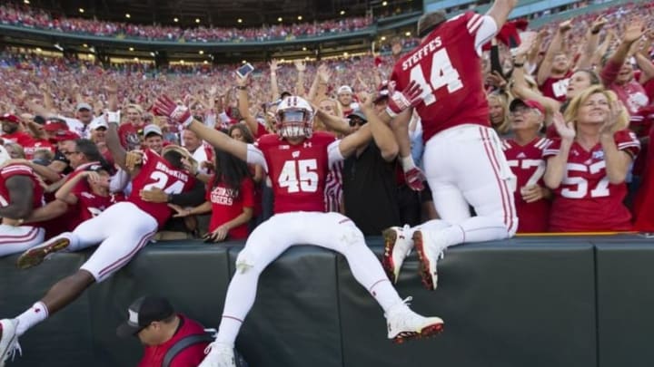 Sep 3, 2016; Green Bay, WI, USA; Wisconsin Badgers players celebrate defeating the LSU Tigers by doing the Lambeau Leap following the game at Lambeau Field. Mandatory Credit: Jeff Hanisch-USA TODAY Sports