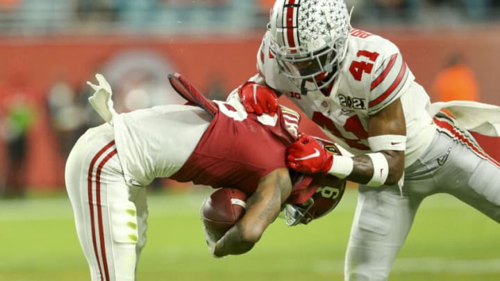 Jan 11, 2021; Miami Gardens, Florida, USA; Alabama wide receiver DeVonta Smith (6) is brought down by Ohio State safety Josh Proctor (41) during the College Football Playoff National Championship Game in Hard Rock Stadium. Mandatory Credit: Gary Cosby-USA TODAY Sports