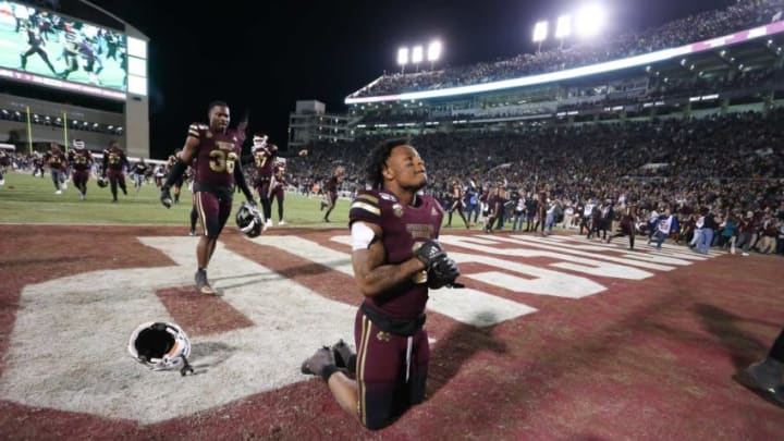 Mississippi State's Kylin Hill (8) kneels in the end zone following the win. MSU players celebrate after winning the Egg Bowl 21-20. Mississippi State and Ole Miss played in the Egg Bowl on Thursday, November 28, 2019 at Davis Wade Stadium in Starkville.2019 Egg Bowl