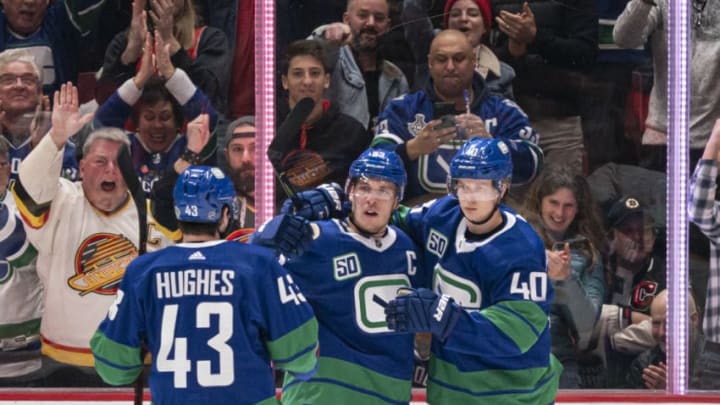 Vancouver Canucks, Bo Horvat #53, Quinn Hughes #43 and Elias Pettersson #40. (Photo by Rich Lam/Getty Images)