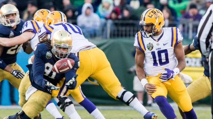 Dec 30, 2014; Nashville, TN, USA; Notre Dame Fighting Irish defensive lineman Sheldon Day (91) recovers a fumble by Louisiana State Tigers quarterback Anthony Jennings (10) in the third quarter of the Music City Bowl at LP Field. Notre Dame won 31-28. Mandatory Credit: Matt Cashore-USA TODAY Sports