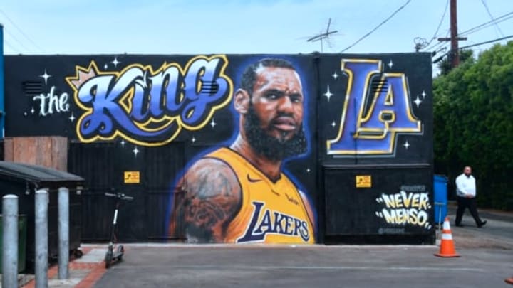 A man walks by a mural of LeBron James in a Los Angeles Lakers jersey in Venice, California.