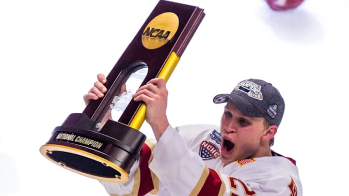 CHICAGO, IL - APRIL 8: Logan O'Connor #24 of the Denver Pioneers celebrates a victory against the Minnesota Duluth Bulldogs by raising the championship trophy after the 2017 NCAA Division I Men's Hockey Frozen Four Championship final at the United Center on April 8, 2017 in Chicago, Illinois. The Pioneers won the national championship 3-2. (Photo by Richard T Gagnon/Getty Images)