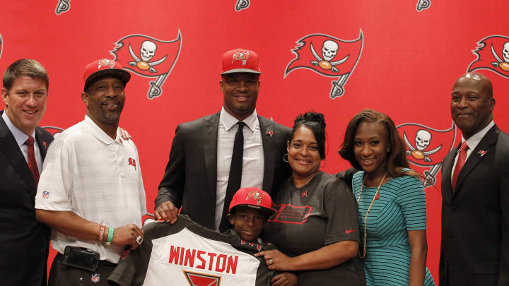 May 1, 2015; Tampa, FL, USA; Tampa Bay Buccaneers quarterback Jameis Winston (3), number one overall draft pick, poses with general manager Jason Licht, head coach Lovie Smith and family during a press conference at One Buc Place. Mandatory Credit: Kim Klement-USA TODAY Sports