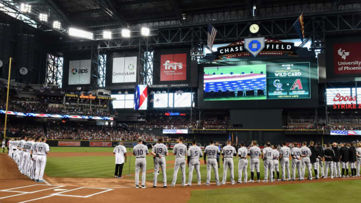 PHOENIX, AZ - OCTOBER 04: Members of the Colorado Rockies and Arizona Diamondbacks stand for the National Anthem before the start of the National League Wild Card game at Chase Field on October 4, 2017 in Phoenix, Arizona. (Photo by Norm Hall/Getty Images)