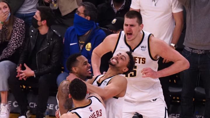 Denver Nuggets guard Monte Morris (11) celebrates with center Nikola Jokic (15), guard Austin Rivers (25) and guard Bryn Forbes (6) after scoring a three point basket at the buzzer during the fourth quarter against the Golden State Warriors at Chase Center on 16 Feb. 2022. (Kelley L Cox-USA TODAY Sports)