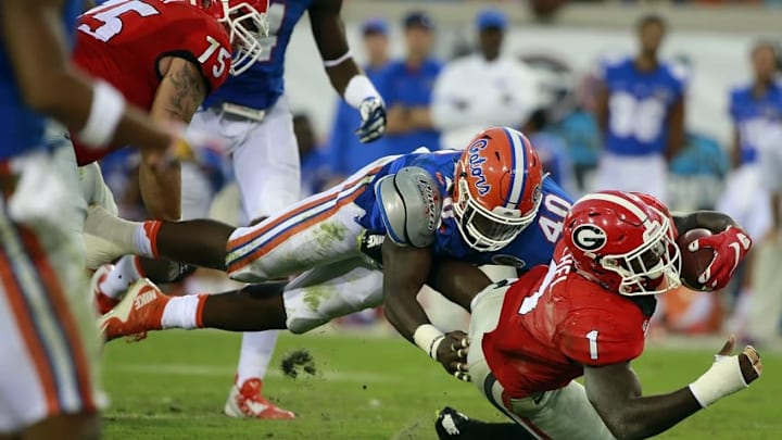 Oct 31, 2015; Jacksonville, FL, USA; Georgia Bulldogs running back Sony Michel (1) runs with the ball as Florida Gators linebacker Jarrad Davis (40) defends during the second half at EverBank Stadium. Florida Gators defeated the Georgia Bulldogs 27-3. Mandatory Credit: Kim Klement-USA TODAY Sports